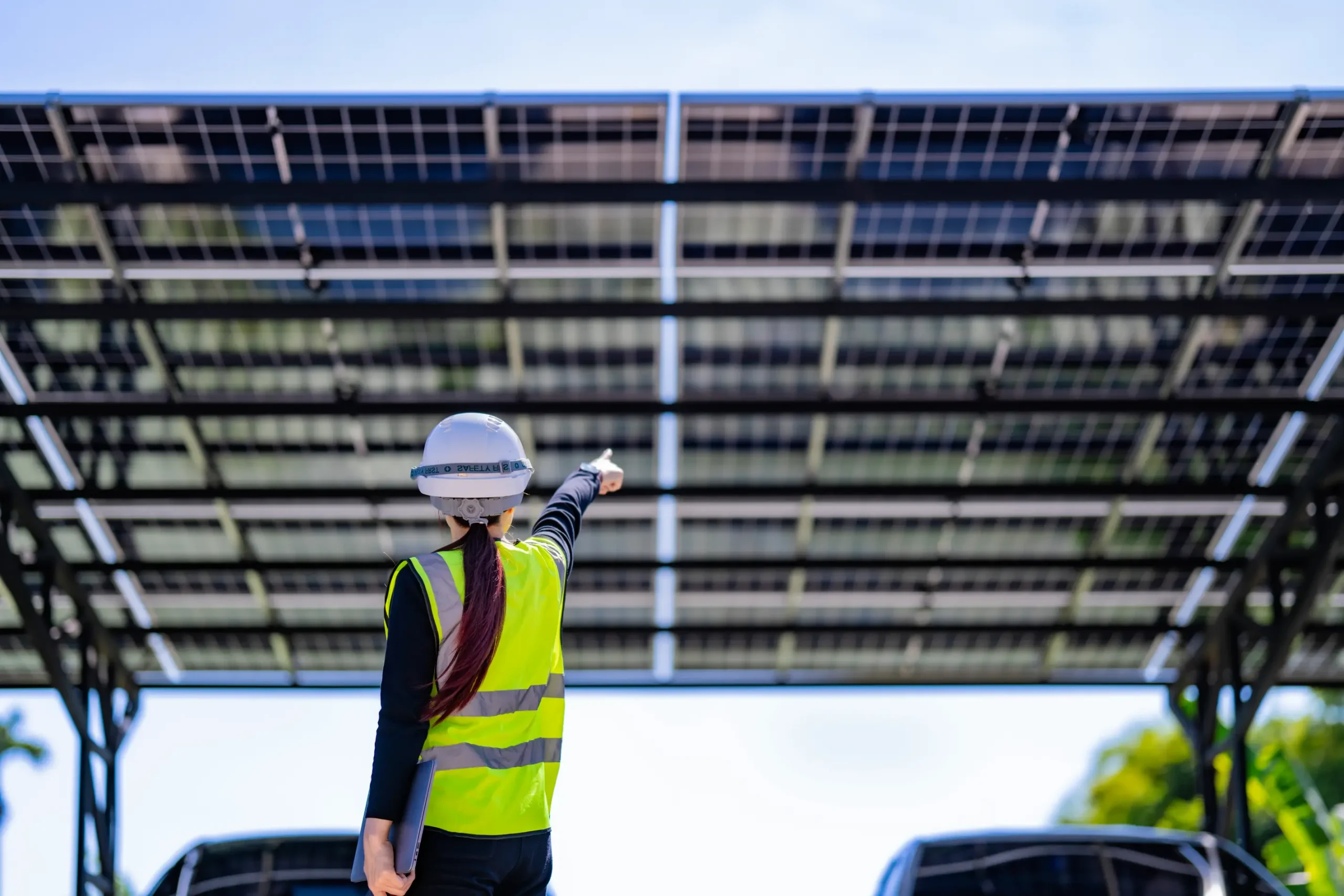 Engineer inspecting a solar parking canopy