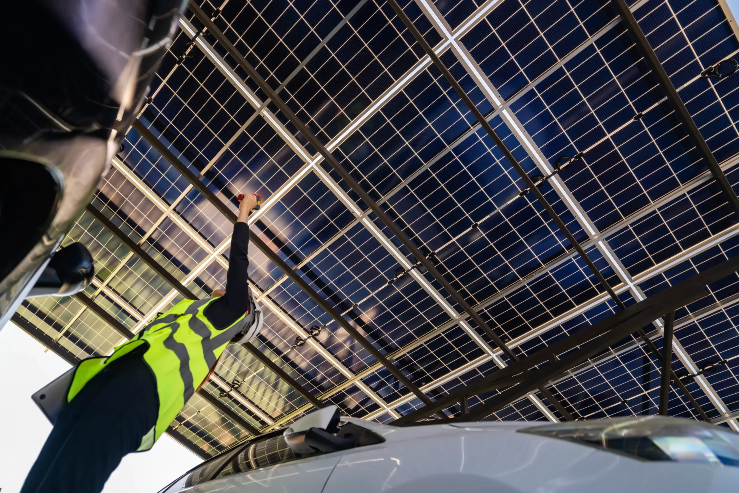 Technician checking the underside of solar carport panels