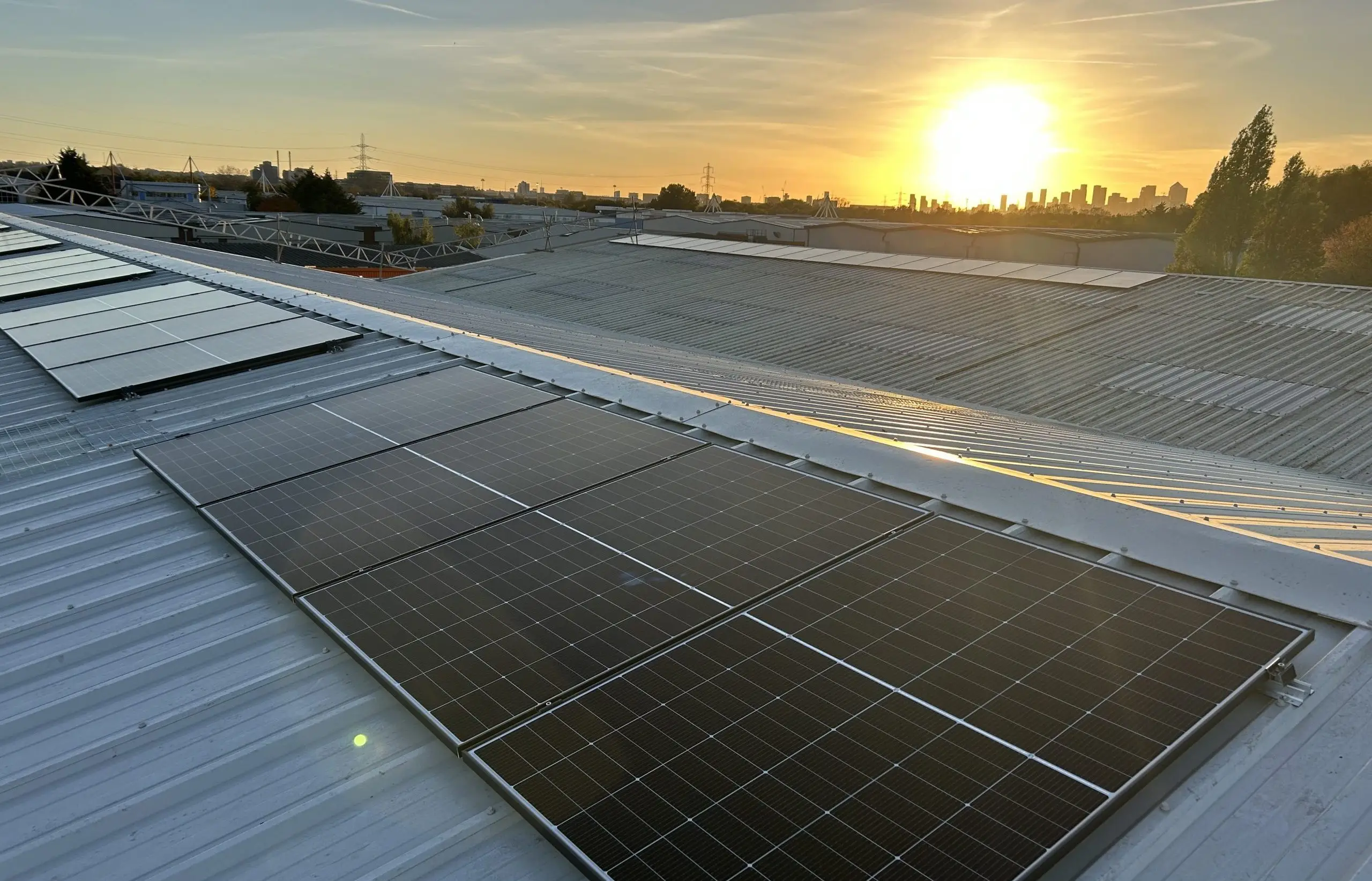 Solar installation on an industrial roof at sunrise