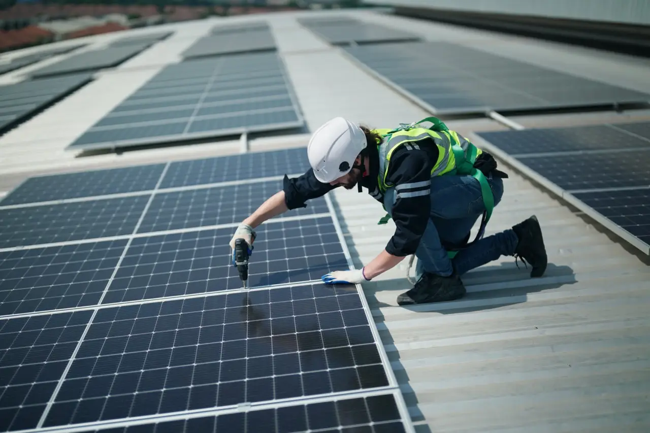 Technician checking a roof-mounted solar panel